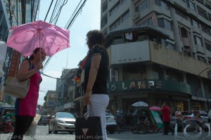 Two Chinese Ladies Chatting At A Street Corner