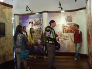 Leo, still in full rider gear, looks at several displays retelling the history of Barasoain Church, the Malolos Constitution, and the Philippines.